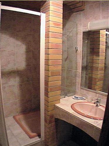 a bathroom with a sink and a shower at Hôtel LA PERGOLA in Amélie-les-Bains-Palalda