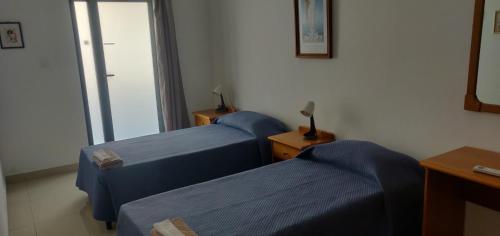 a room with two beds and a window at Comfortable vacation home with great views in Mellieħa