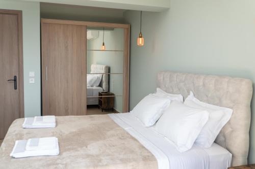 a bedroom with a large bed with white pillows at THISEFS luxury apartments Kefalonia in Antipata