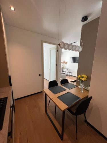 a dining room with a table and chairs at New apartment near the PALM tree in Uzhhorod