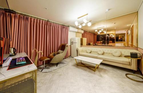 a living room with a couch and a table at Hotel Ravi in Seoul
