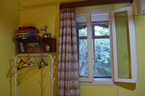 a window with a curtain in a room at Περγαμόντο in Chios