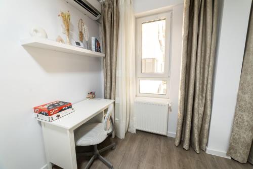 a white desk in a room with a window at Natural Luxury Studio Central Adress Residence in Bucharest
