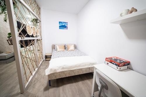 a bedroom with two beds and a staircase at Natural Luxury Studio Central Adress Residence in Bucharest
