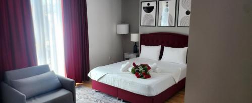 a bedroom with a bed with a christmas wreath on it at Hotel Fantazia Oradea - Self Check In & Out in Oradea