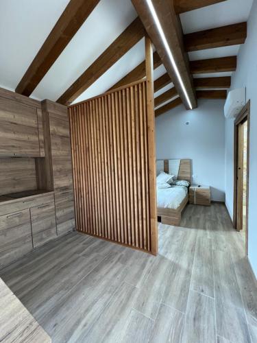 a bedroom with a bed and wooden walls at AMC Boente in Arzúa