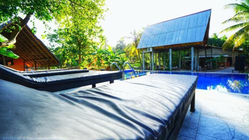 two mattresses on a patio next to a house at The Sigiri Roar in Sigiriya