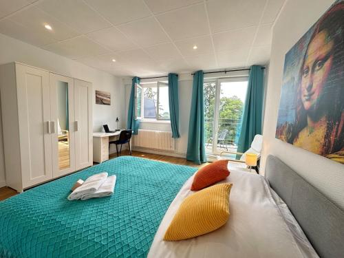 a bedroom with a large bed with a large painting on the wall at M Lorry Pop Art 3 chambres avec balcons proche Metz in Metz