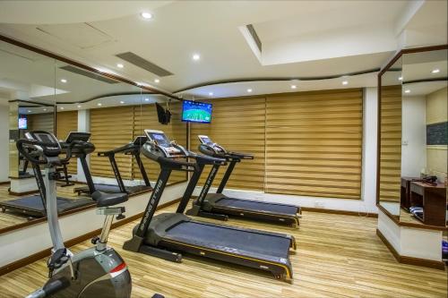 a gym with several tread machines in a room at Bengal Blueberry in Dhaka