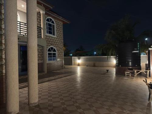 a courtyard of a building at night at Deluxe Kingsize Bedroom In Tema in Afienya