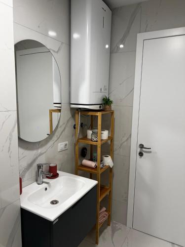 a bathroom with a sink and a mirror at Blush Studio at Rose in Prishtinë