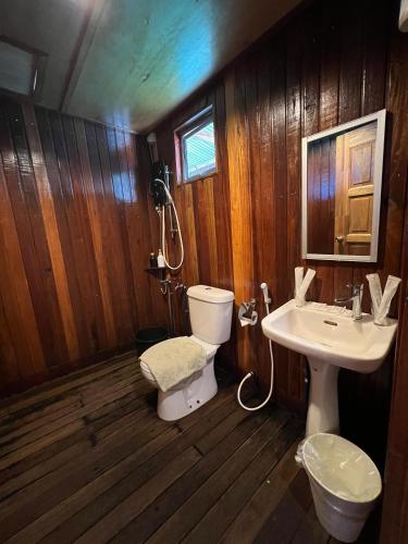 a bathroom with a toilet and a sink at Nusakuya Resort in Semporna