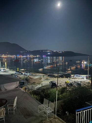a view of a harbor at night with chairs at Room with amazing sea view in Himare