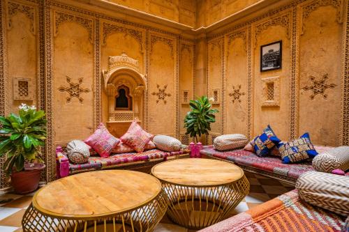 a living room with a couch and two tables at Tripli Hotels Surya Villas in Jaisalmer