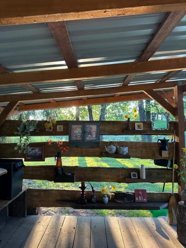 a wooden pergola with a view of a garden at Glamp Juodis in Ubiškės