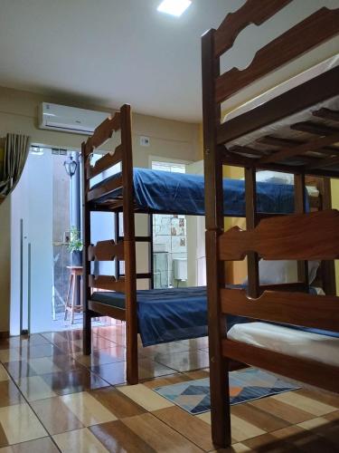 two bunk beds in a room with a window at Spacious COP 30 home - Casa espaçosa COP 30 in Belém
