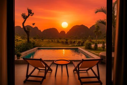 a sunset view from a patio with two chairs and a pool at Tam Coc Horizon Retreat in Vũ Lâm