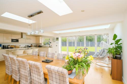 a kitchen and dining room with a table and chairs at "Tranquil Village Hideaway Bungalow"near Kings Lynn in King's Lynn