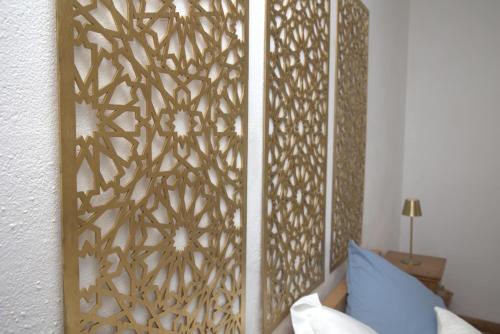 a room with a wall with a wooden partition with a bed at Pure Gardères in Monlezun