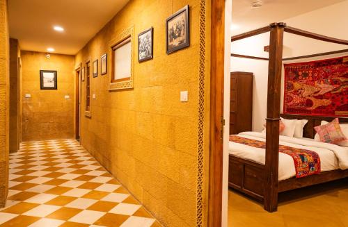 a hotel room with a bed and a checkered floor at Tripli Hotels Surya Villas in Jaisalmer
