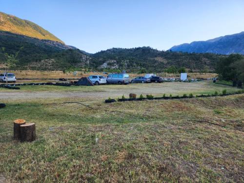 a parking lot with cars parked in a field at Camping Shtepez in Gjirokastër