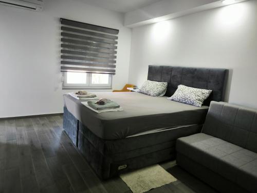 a bedroom with a large bed and a couch at Apartment with pool, accessible for people with disabilities, near Zadar in Bibinje