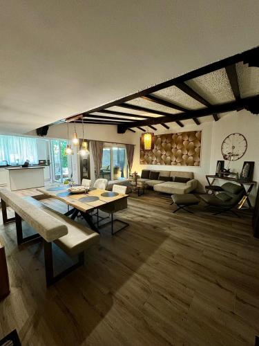 a large living room with a table and a couch at Waldliebe in Bad Peterstal
