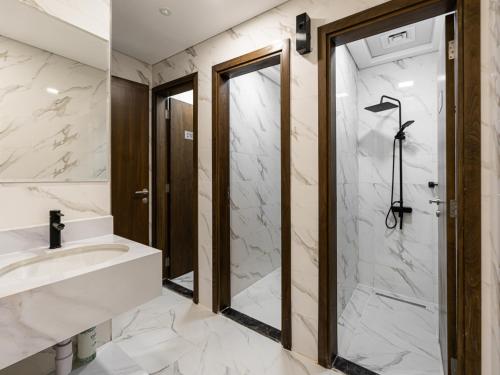a bathroom with a shower and a sink at Savis Homes - Luxury Brand New Studio in Elysee III in JVC in Dubai
