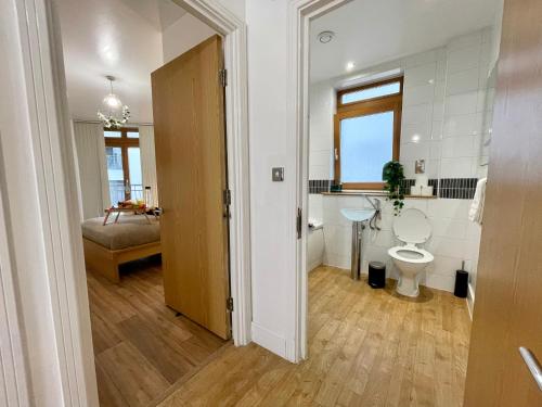 a bathroom with a toilet and a sink at Marshall Street Retreat in Birmingham