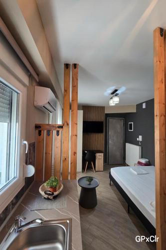 a room with a bed and a sink at Gpxclr MicroLuxeSuite in Larisa