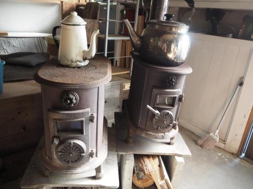an old stove with a tea kettle on top of it at Guesthouse Nishiki in Chichibu