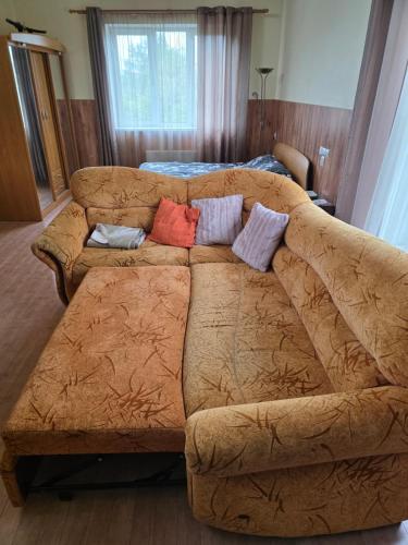 a couch in a living room with pillows on it at Family house in Dobele in Dobele