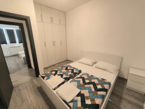 a small bedroom with a bed with a mirror at NDK NEST 2BR Apartment in the Heart of Sofia in Sofia