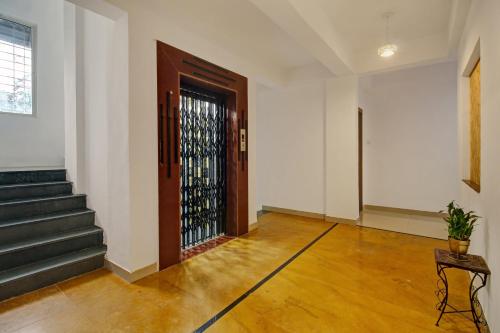 an empty room with a door and a stair case at Super Collection O Grey House in Pune