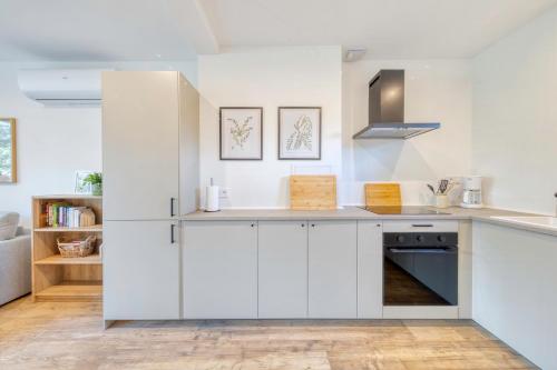 a kitchen with white cabinets and a counter top at Bory Za Oknem in Tleń