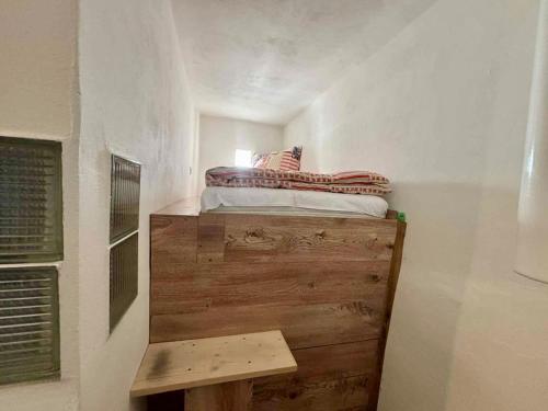 a small bedroom with a bed on a wooden platform at Apartmán Pod Hvězdami in Štítary