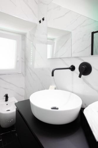 a white bathroom with a sink and a toilet at Diamond Suite - Appartamento con Idromassaggio - Molfetta in Molfetta