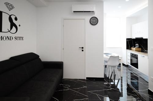 a living room with a black couch and a table at Diamond Suite - Appartamento con Idromassaggio - Molfetta in Molfetta