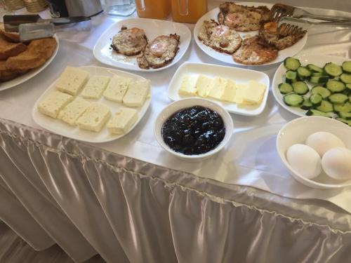 a table with cheese and other foods on it at Vila Culli in Përmet