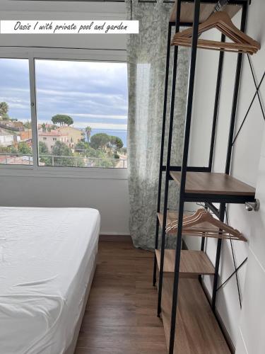 a room with a ladder next to a bed and a window at Villa Oasis Costa Brava in Lloret de Mar