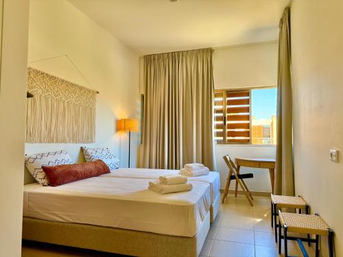 a hotel room with a bed and a table at Salgados Premium Beach Villa 4 Suites in Guia