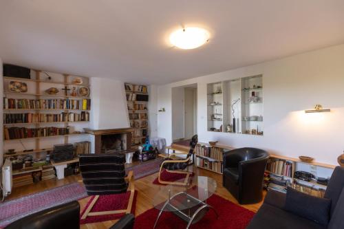 a living room filled with furniture and a fireplace at Kućica na brdu-Zaklopača in Zaklopača