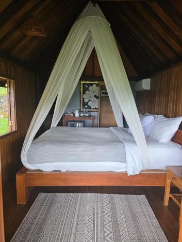 Postel nebo postele na pokoji v ubytování Bali Rahayu Homestay