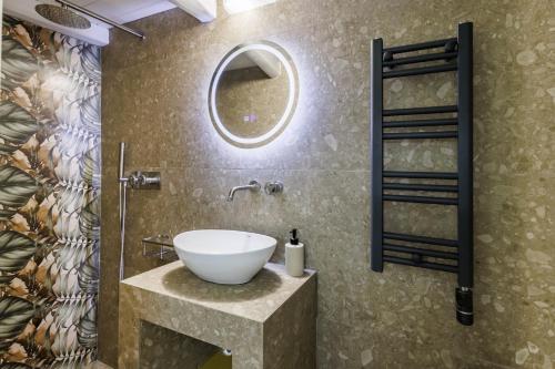 a bathroom with a sink and a mirror at Maritina Skopelos Maisonette in Skopelos Town