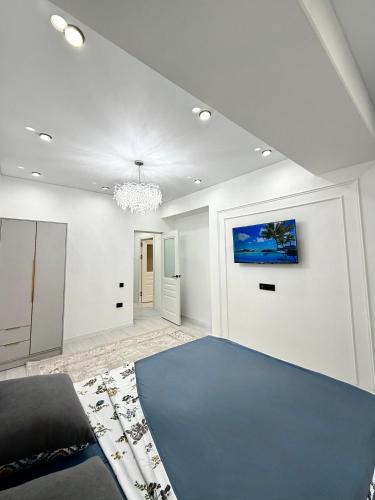 a living room with a blue rug on the floor at 2-х комнатный апарт в Джале Minimalistic in Bishkek