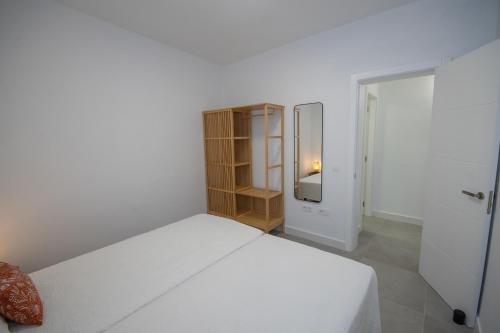 Ένα ή περισσότερα κρεβάτια σε δωμάτιο στο Apartamentos Marmolejos