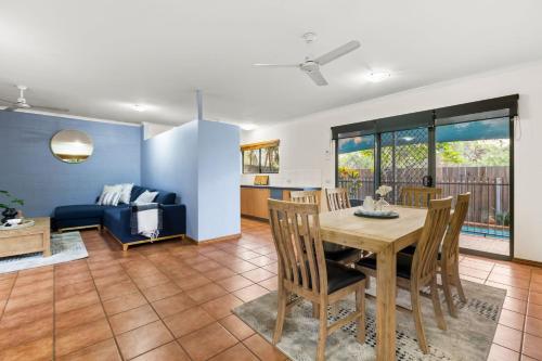 a dining room and living room with a table and chairs at Beach Retreat on Demco in Broome