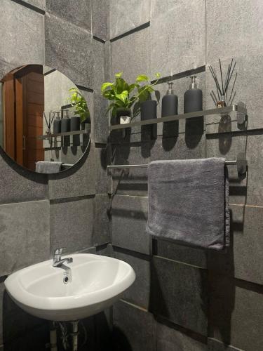 a bathroom with a sink and a mirror at Kamanaya Ubud in Ubud