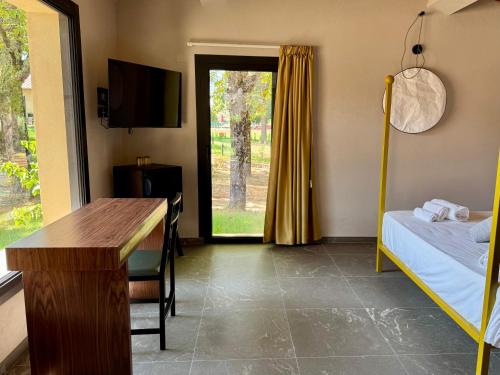 a room with a bed and a desk and a window at The Monteleone Umbria Retreat in Monteleone dʼOrvieto