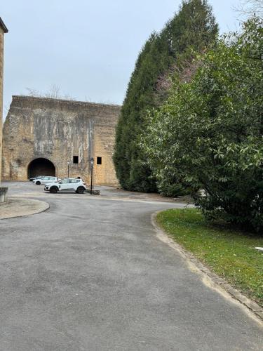 a car parked in front of a building with a tunnel at Evasio Suite in Sedan